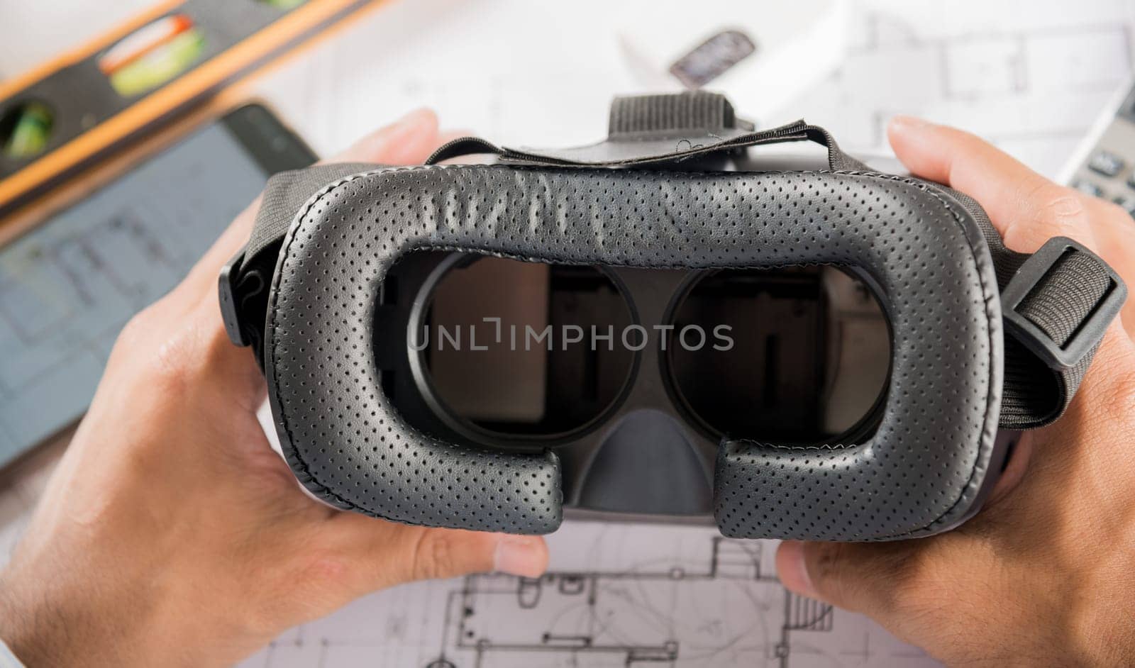 Architectural building design hold back 3D VR glasses and construction plans with blueprints paper project plans, designing man edit building or architecture, technology industry, Architect workplace