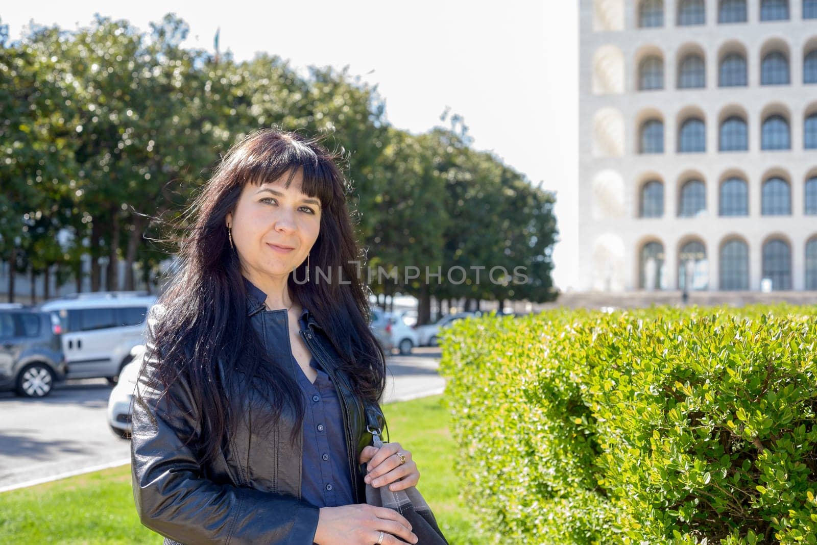 portrait of an ukrainian girl visiting Rome, palace of civilization and work as background