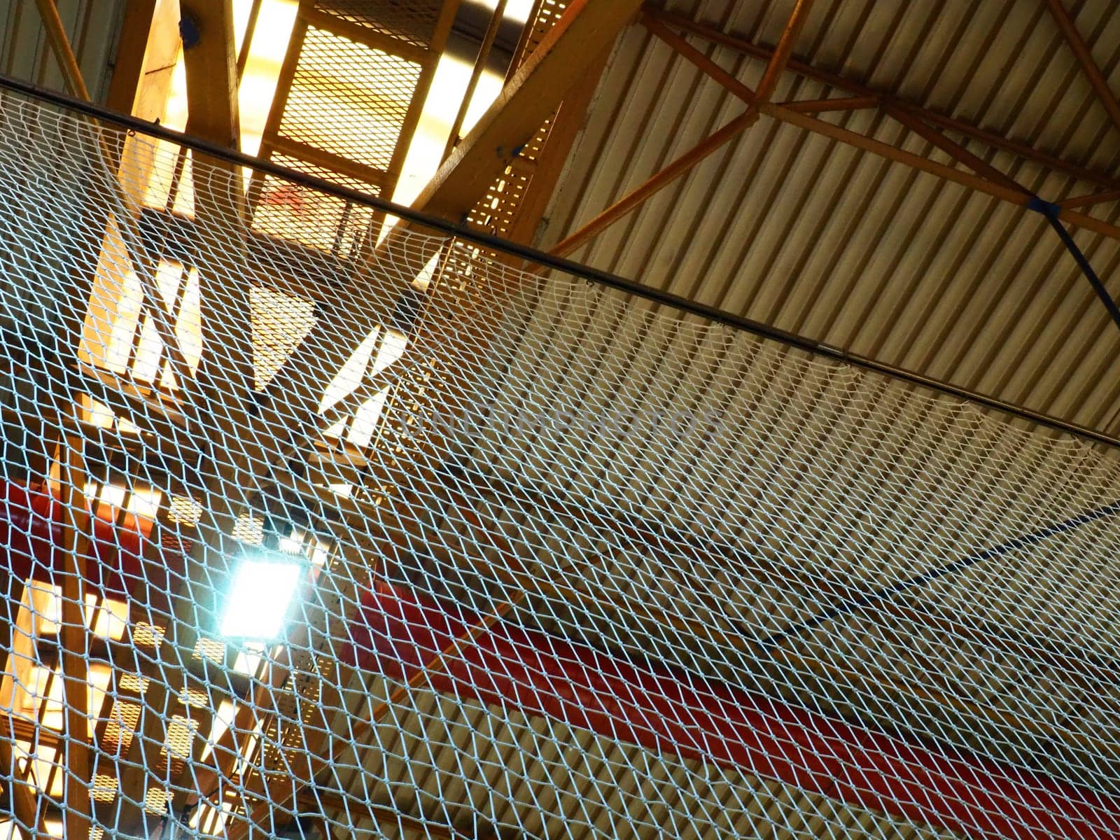 The roof of a hangar, a production hall or a sports hall. Metal structures, beams, supporting elements. Ventilation systems in large halls and rooms. Skylights. Industrial interior