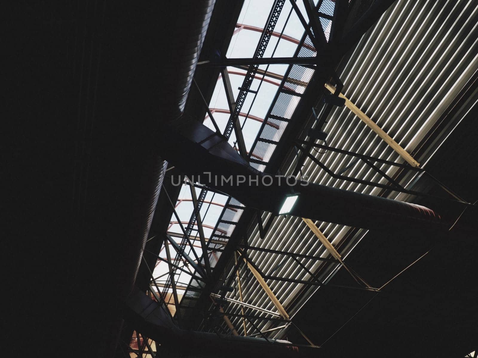 The roof of a hangar, a production hall or a sports hall. Metal structures, beams, supporting elements. Ventilation systems in large halls and rooms. Skylights. Industrial interior