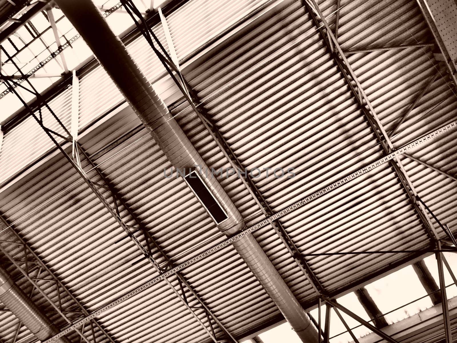 The roof of a hangar, a production hall or a sports hall. Metal structures, beams, supporting elements. Ventilation systems in large halls and rooms. Skylights. Industrial interior