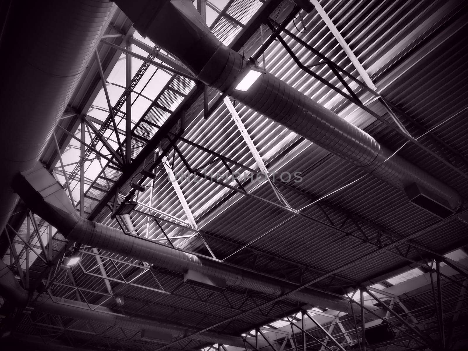 The roof of a hangar, a production hall or a sports hall. Metal structures, beams, supporting elements. Ventilation systems in large halls and rooms. Skylights. Industrial interior