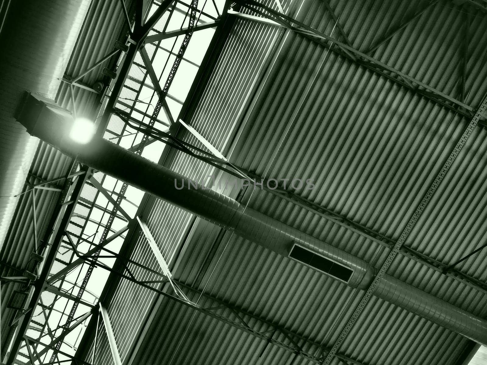 The roof of a hangar, a production hall or a sports hall. Metal structures, beams, supporting elements. Ventilation systems in large halls and rooms. Skylights. Industrial interior