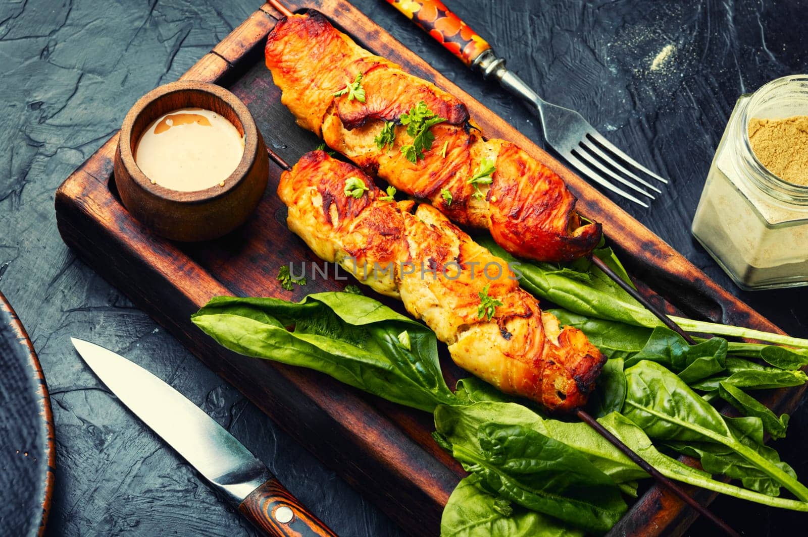 Appetizing chicken meat, chicken breast roasted on wooden skewers. Kebabs on cutting board