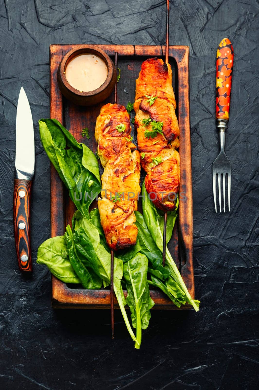 Appetizing chicken meat, chicken breast roasted on wooden skewers. Kebabs on cutting board