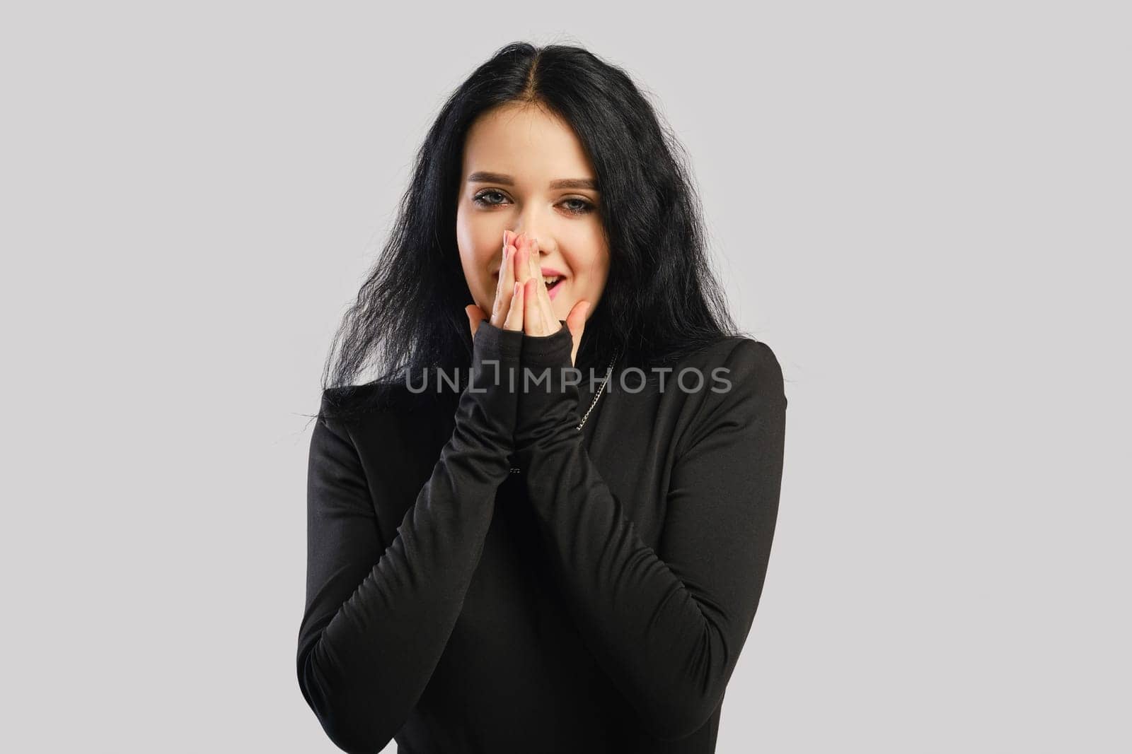 Young pretty woman covered her mouth with her hands in surprise