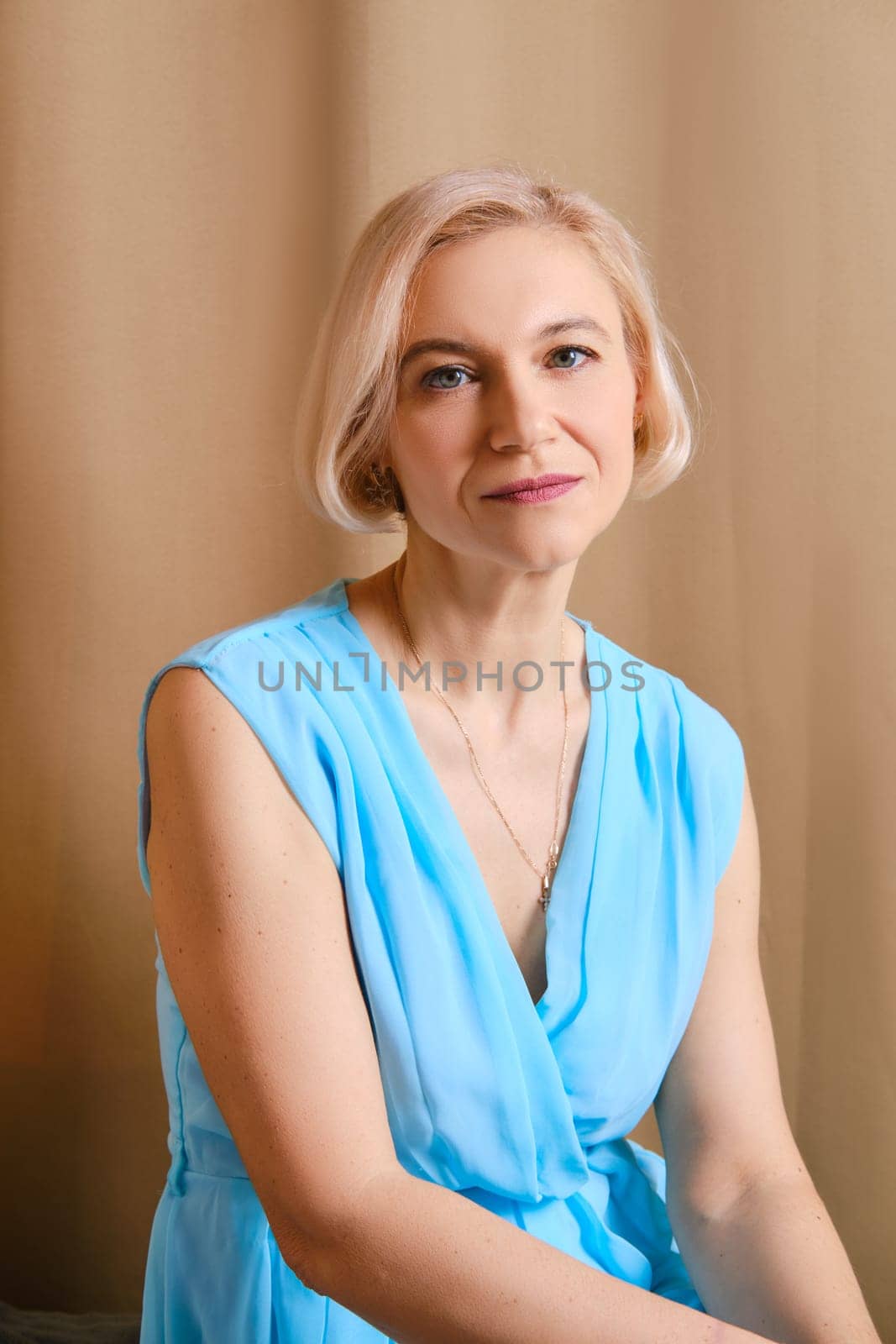 Portrait of senior woman in blue dress