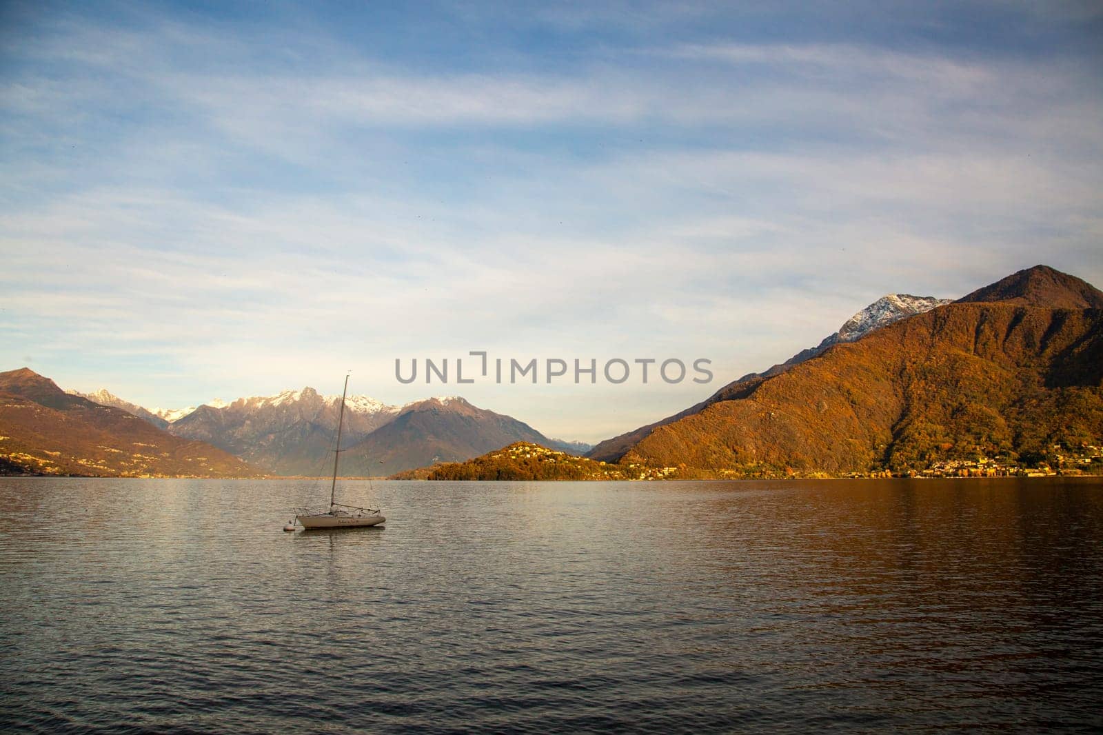 Lonely boat in a lake, sunset light, horizontal view