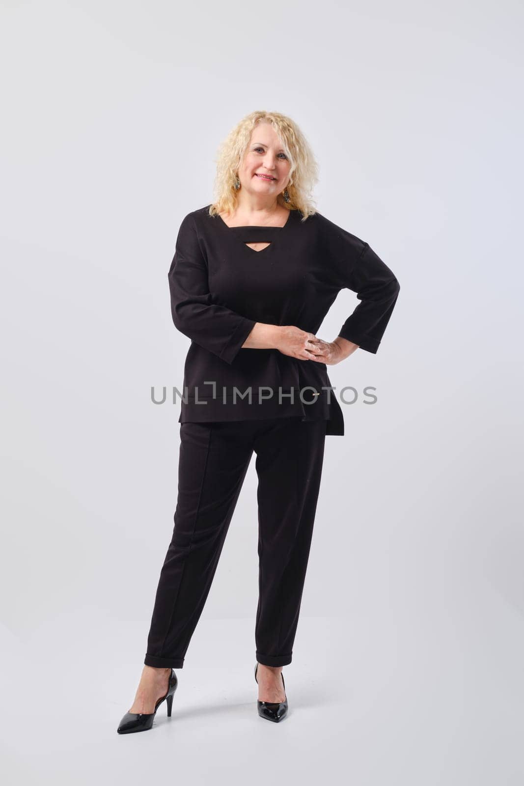 Full length studio portrait of cheerful and confident senior woman