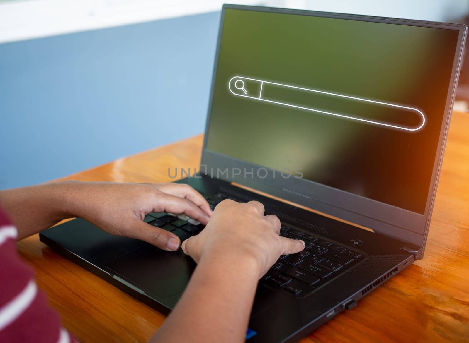 Human hand working on computer and search icon. The concept of searching for information from the internet network.