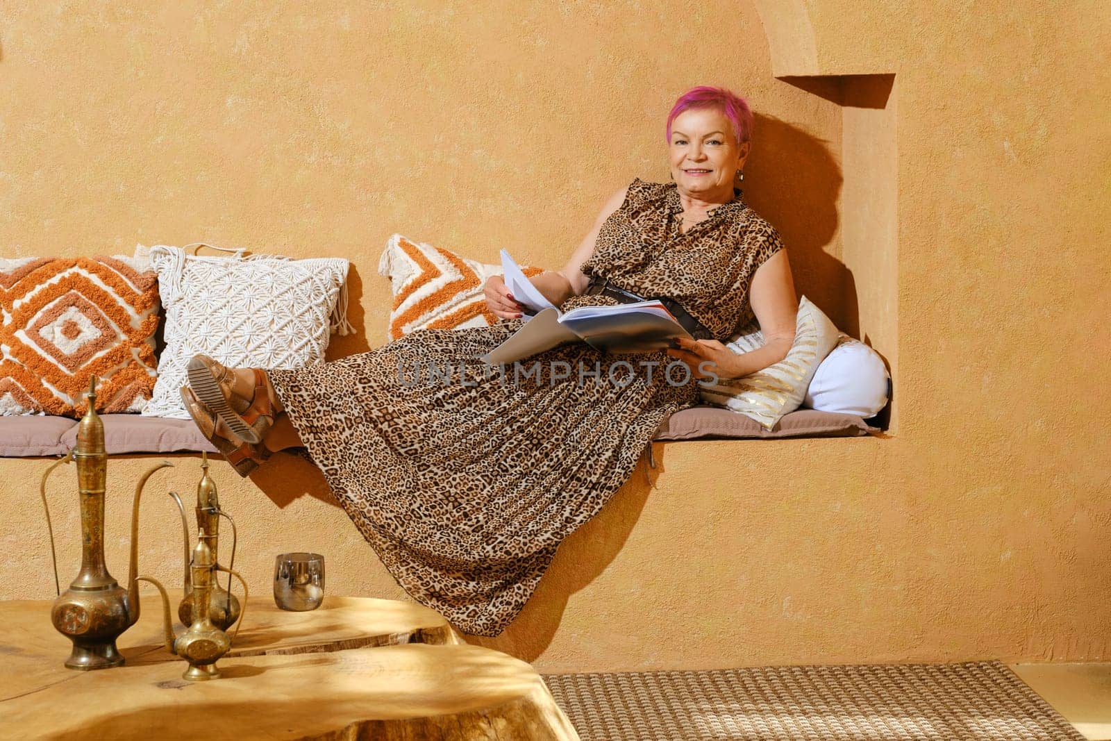 Old woman reading a magazine during trip to Middle East