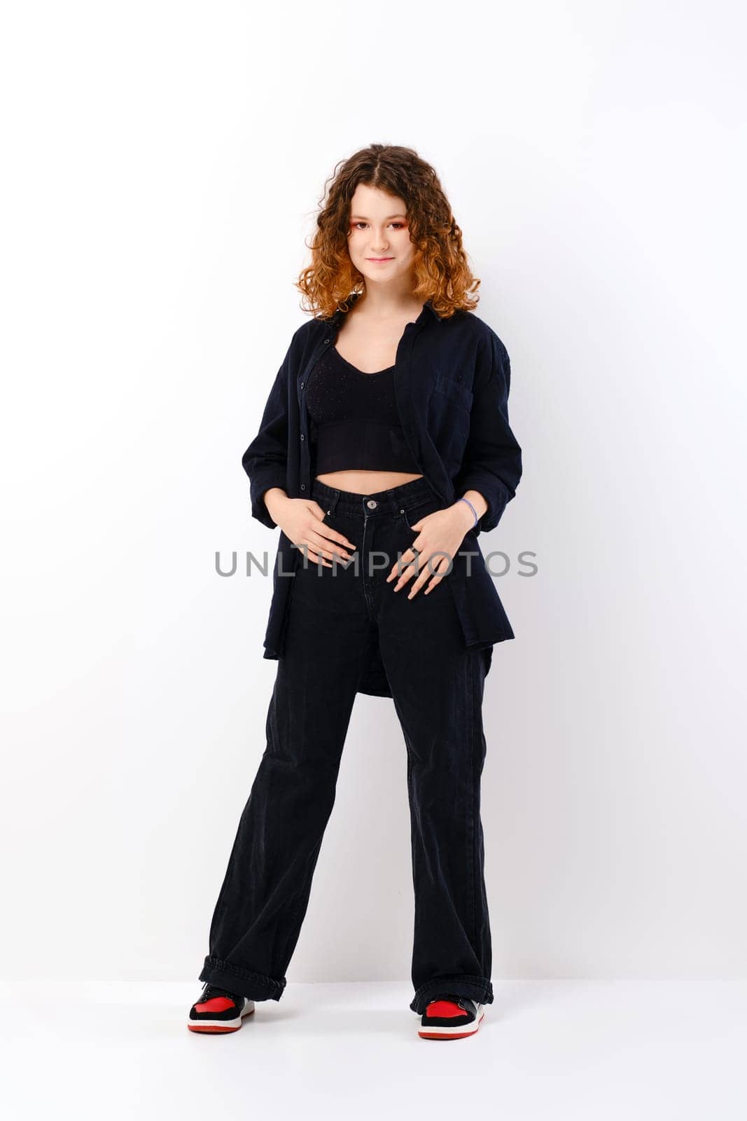 Cute teenager girl in black clothes looking tricky