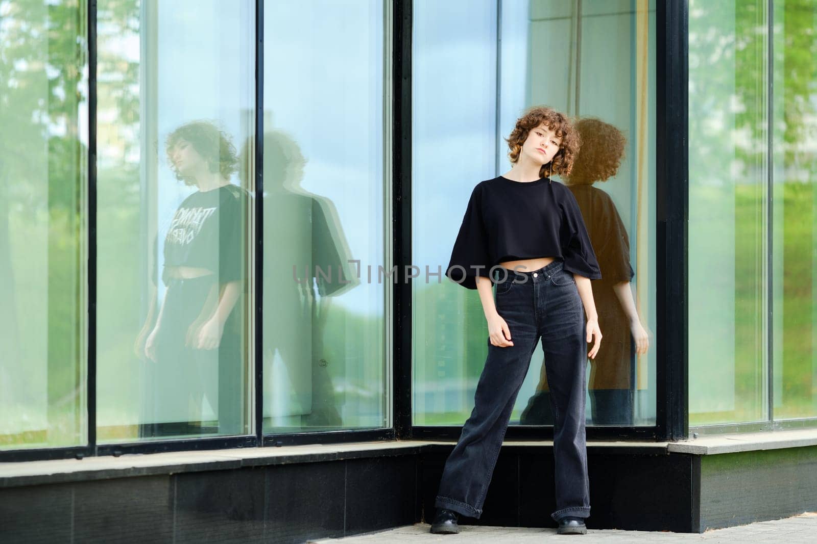 Young teenager model in black clothes outdoors