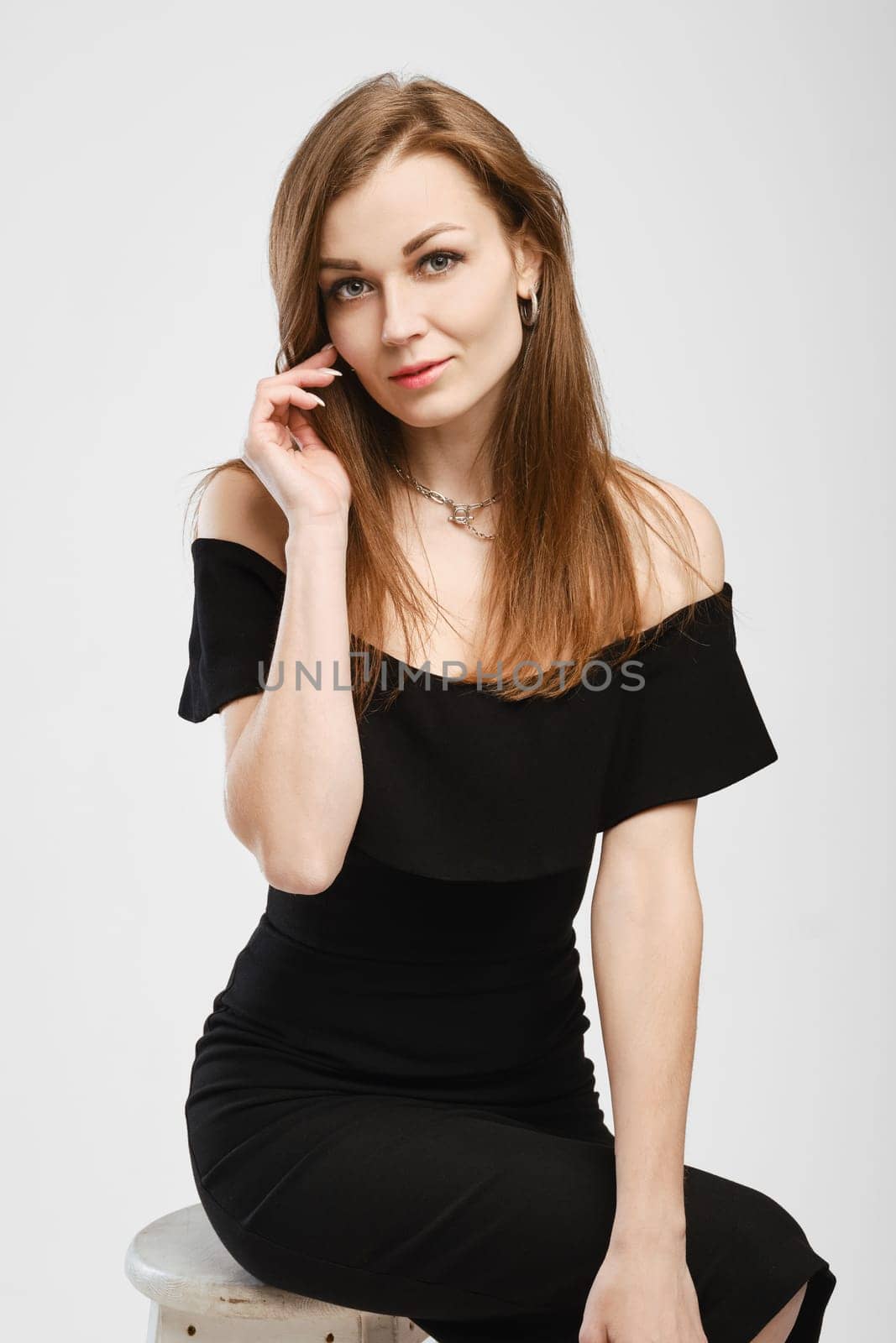 Cute lady in balck dress looking to the camera