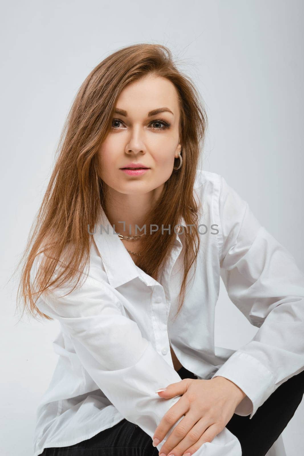 Portrait of beautiful young woman with no makeup looking at camera