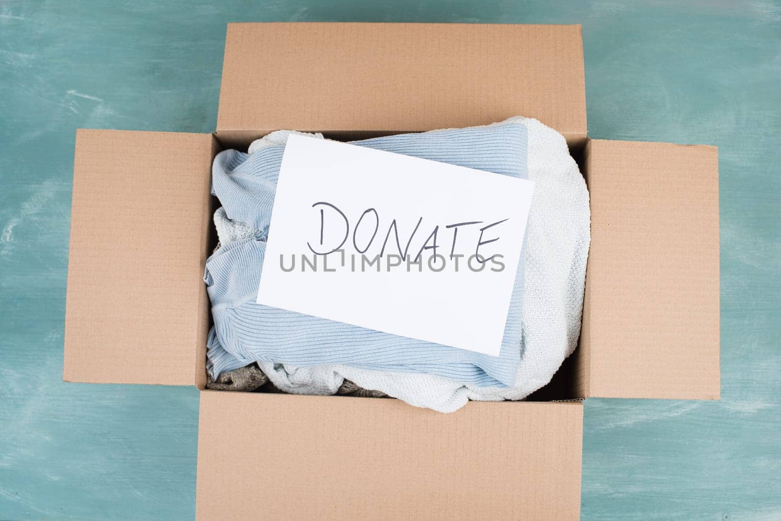 Package with used clothes for donation, second hand use for poor people, welfare and support concept, humanitarian act
