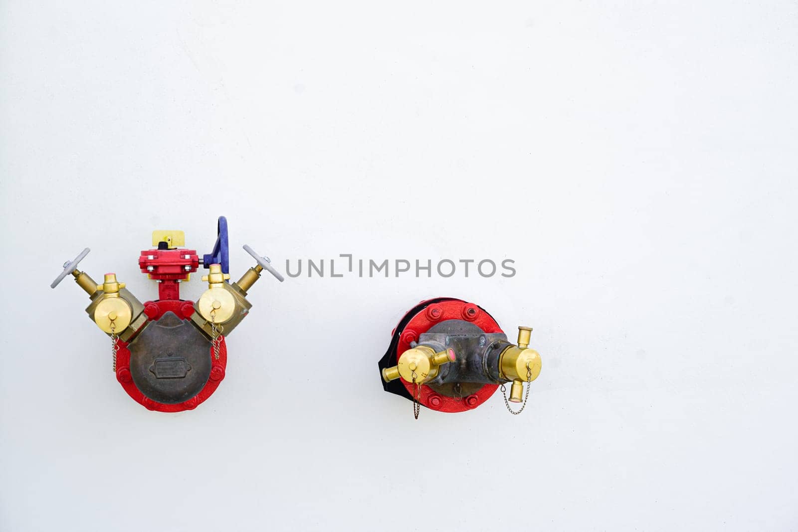 Red fire hydrant system, fire extinguishing system on white wall