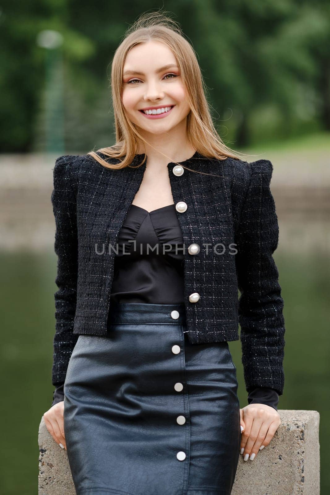 Outdoor portrait of cheerful smiling young woman