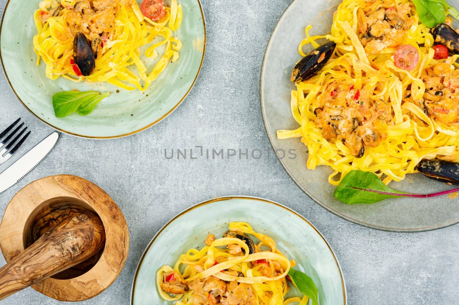 Pasta spaghetti with seafood. Cooking mediterranean food. Light gray background