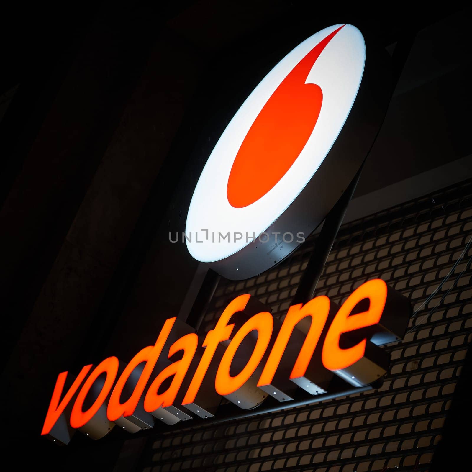 advertisement of the mobile phone provider Vodafone in the city center of Berlin in the evening