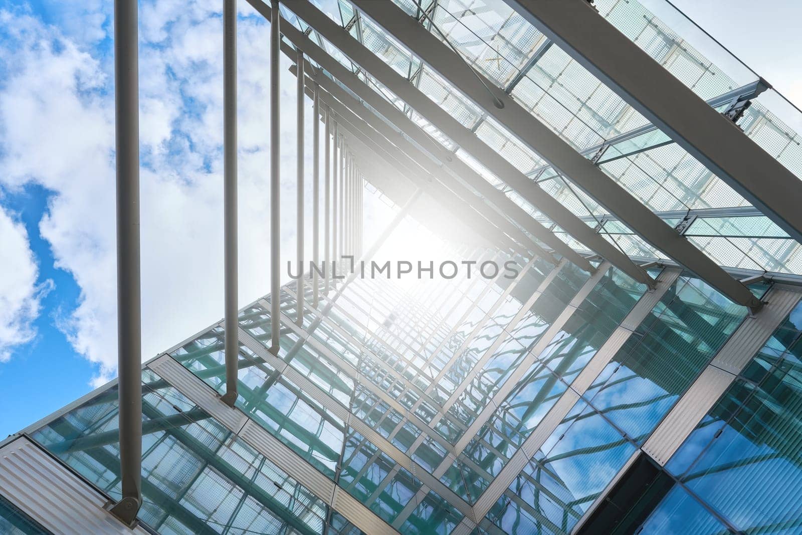 Part of the glass facade on a modern office building in downtown Berlin in blinding sunlight