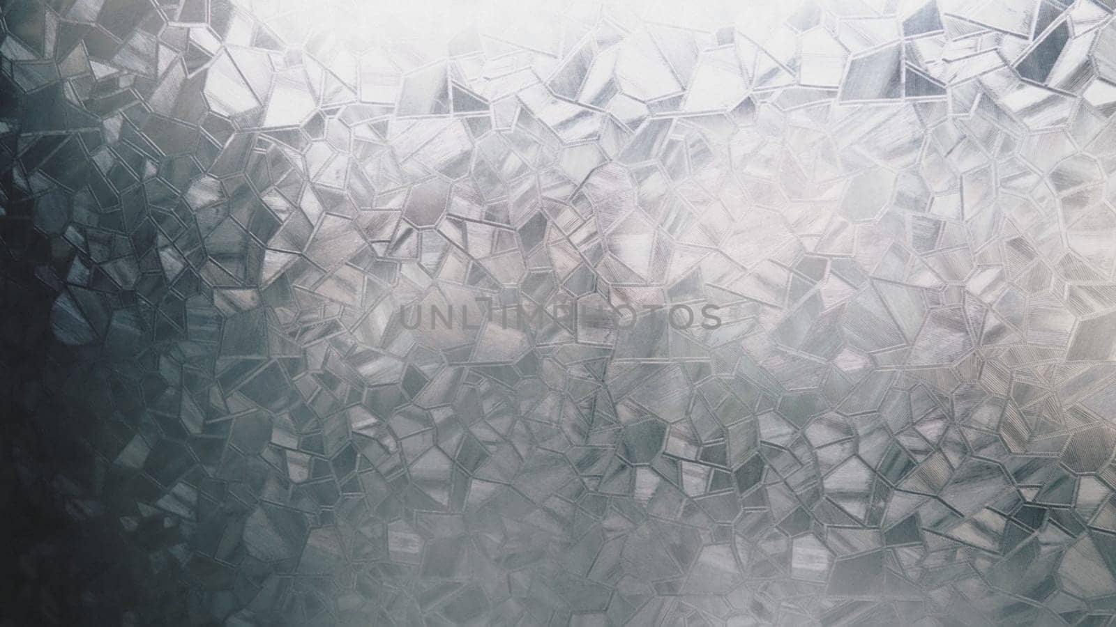 Fluted glass with backlight. Beautiful multicolored refraction of light. Abstract background. Self-adhesive film. Ribbed glass surface. Embossed glass background.