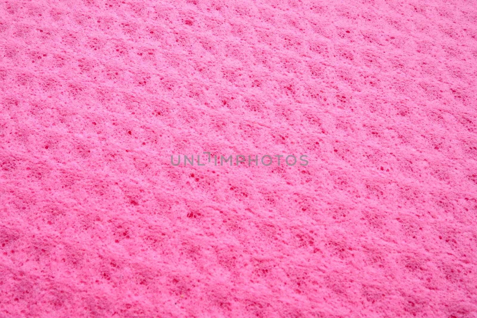 Sponge fibers sponge texture pattern surface close-up pink magenta background.