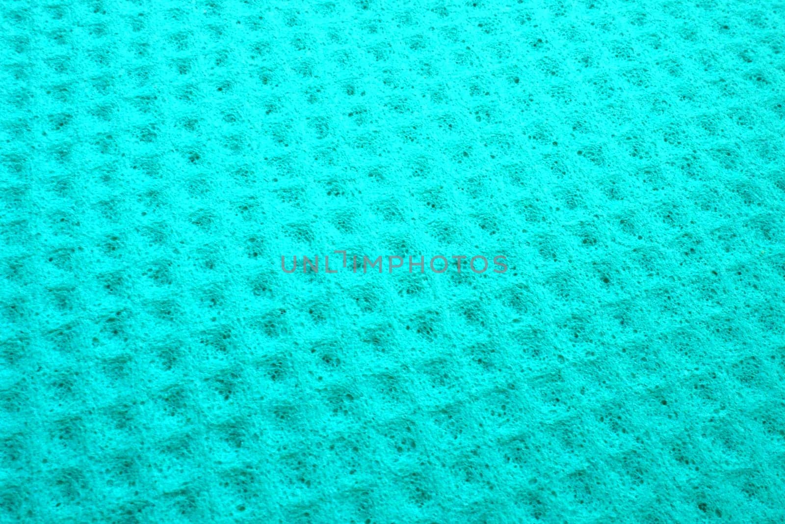 Sponge fibers sponge texture pattern surface close-up green background.