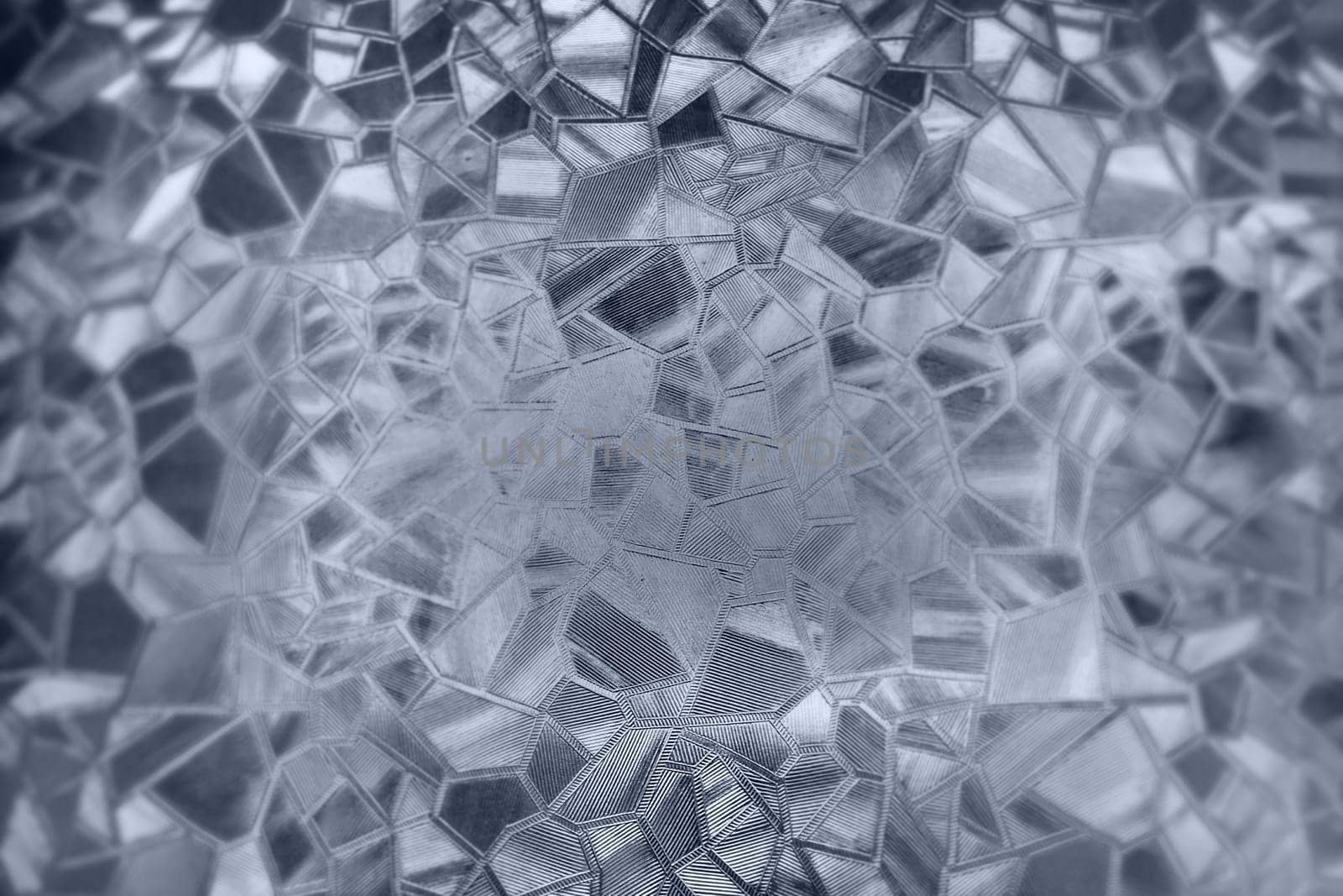 Embossed glass background. Corrugated glass monochrome. Refraction of light in a bumpy transparent surface under backlight. The play of white and gray highlights. Black areas. Abstract background