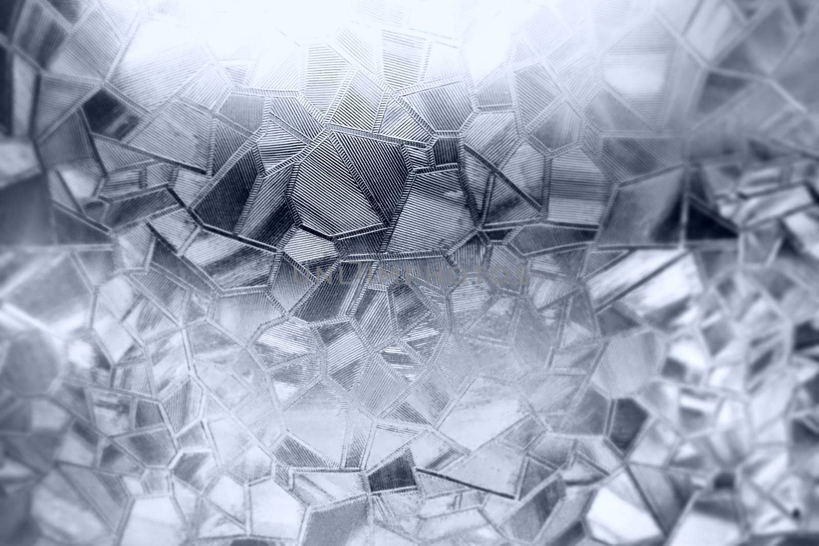 Embossed glass background. Corrugated glass monochrome. Refraction of light in a bumpy transparent surface under backlight. The play of white and gray highlights. Black areas. Abstract background