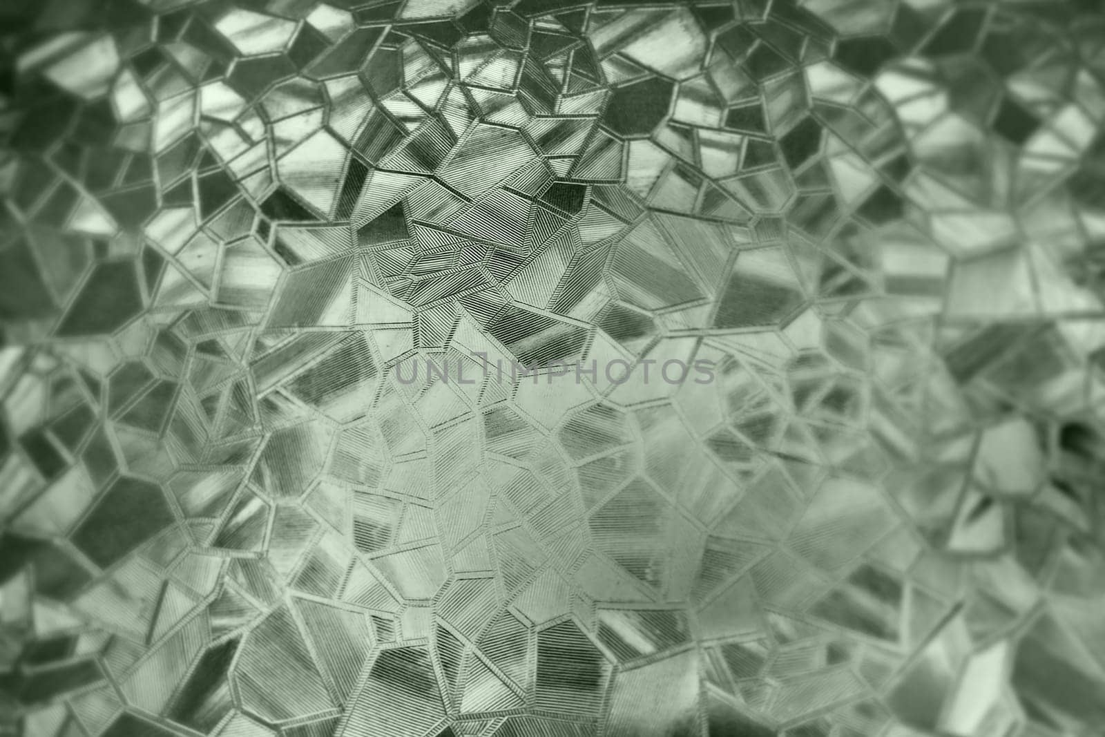 Corrugated glass green background. Abstract pattern on the surface of a window. Protective opaque film