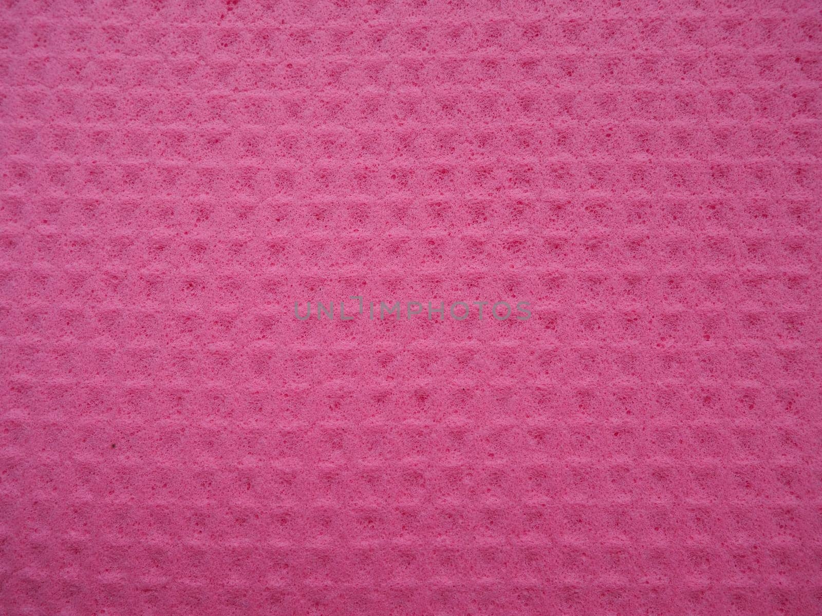Sponge fibers sponge texture pattern surface close-up pink magenta background.
