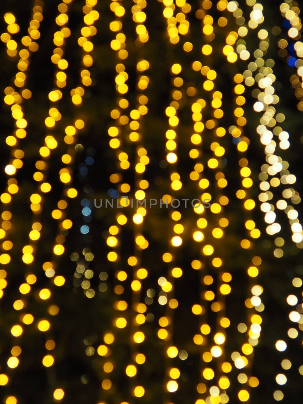 Festive garland. City night light blur bokeh, defocused background. Christmas bokeh. Beautiful lights against the black night sky. Street decoration for New Year and Christmas.