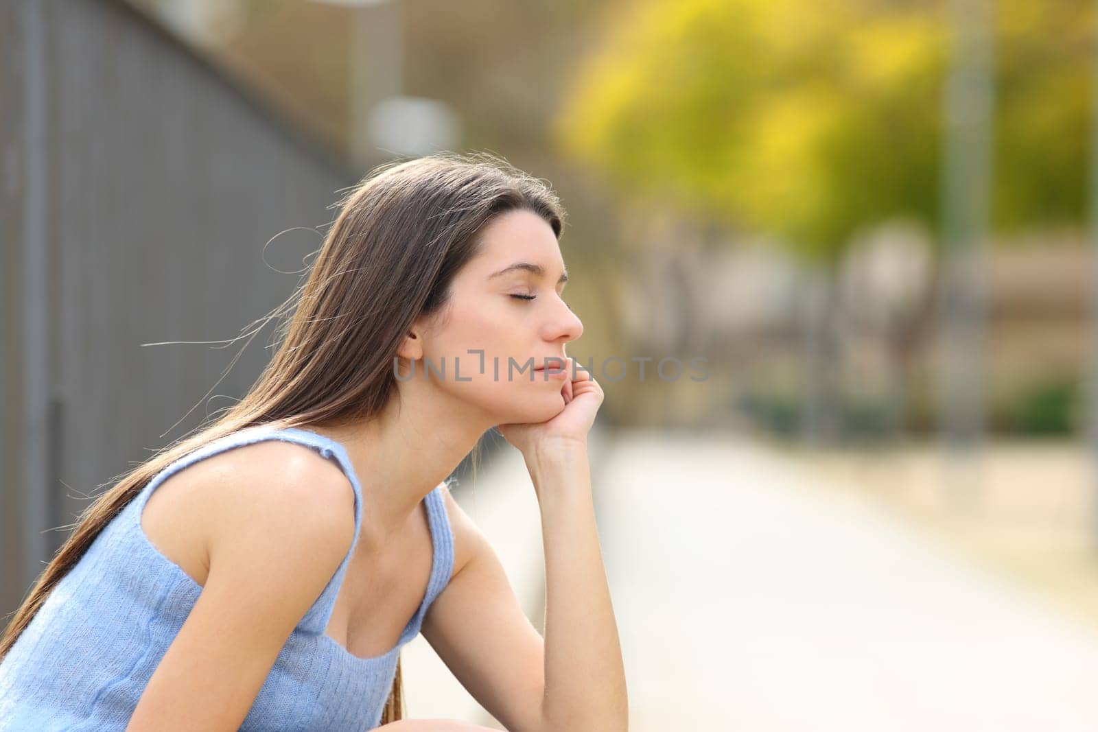 Teen relaxing with closed eyes in a park
