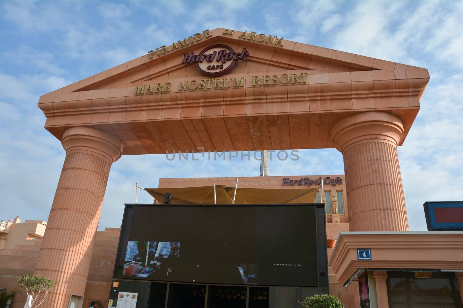 Hard Rock Cafe, Playa de la Americas, Tenerife, Spain August 12, 2022 - Lettering at top of building with big screen and blue sky