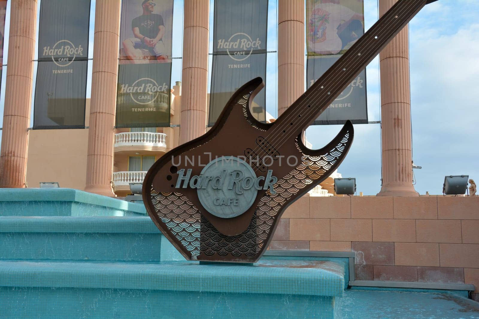 Hard Rock Cafe, Playa de la Americas, Tenerife, Spain August 12, 2022 - Building exterior with a guitar and fountain