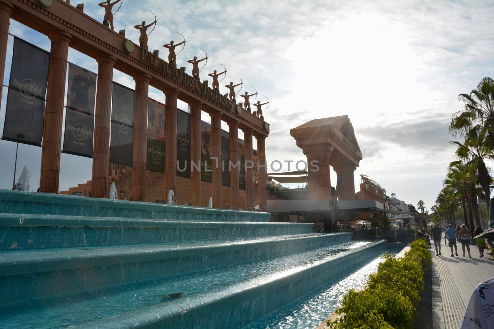 Hard Rock Cafe, Playa de la Americas, Tenerife, Spain August 12, 2022 - Building exterior with guitar, fountain and some archers stone figure, palm, on a street