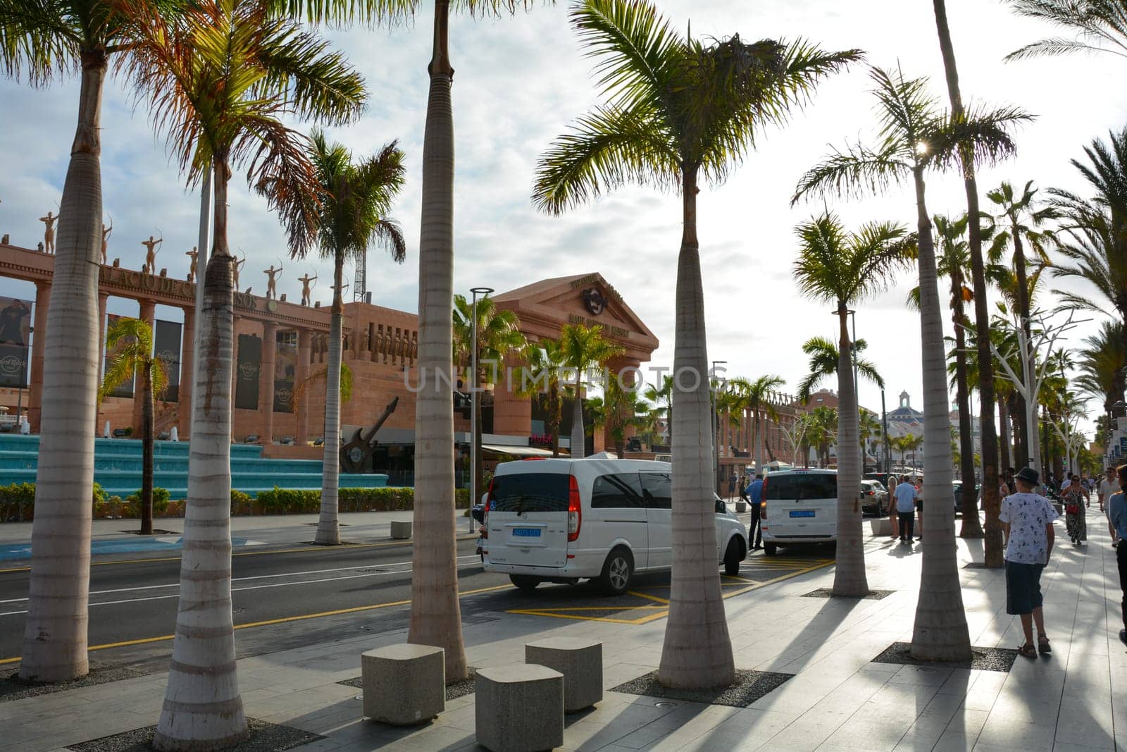 Hard Rock Cafe, Playa de la Americas, Tenerife, Spain August 12, 2022 - View from across the street of the Cafe building with palm trees and sky