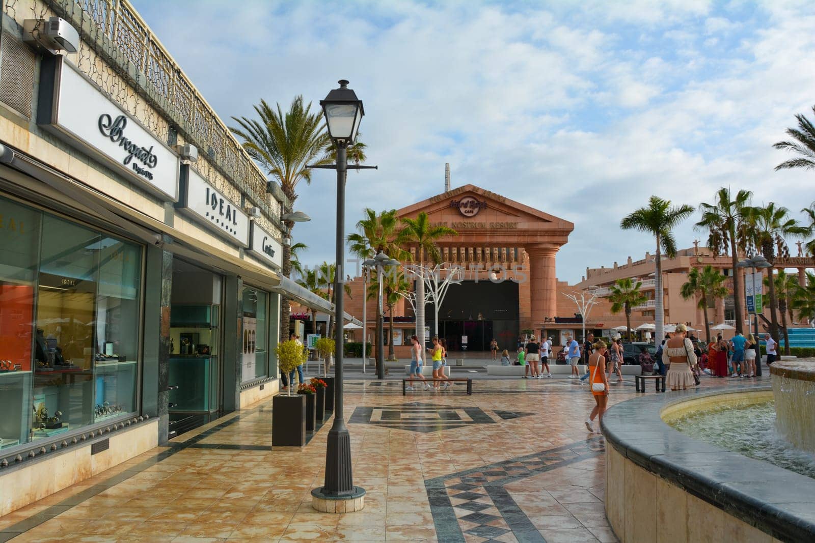Centro Comercial Safari Shopping Mall, Playa de la Americas, Tenerife, Spain August 12, 2022 - Water fountain overlooking the Hard Rock Cafe with blue sky