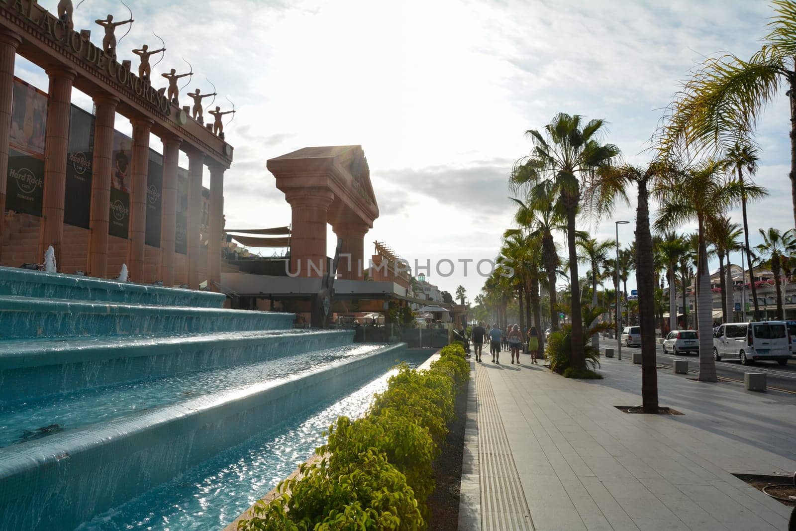 Hard Rock Cafe, Playa de la Americas, Tenerife, Spain August 12, 2022 - Building exterior with guitar, fountain and some archers stone figure, palm, on a street