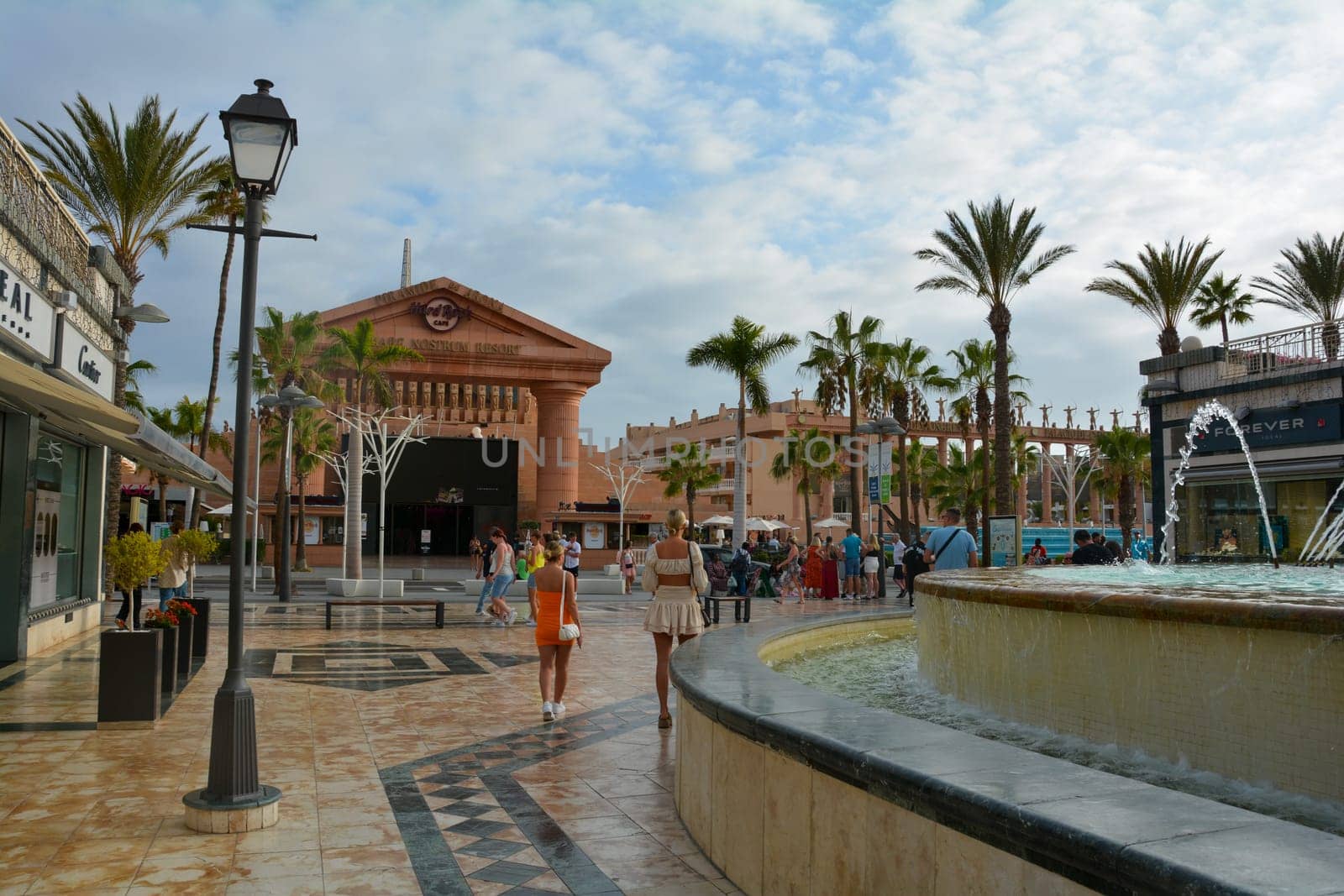 Centro Comercial Safari Shopping Mall, Playa de la Americas, Tenerife, Spain August 12, 2022 - Water fountain overlooking the Hard Rock Cafe with blue sky