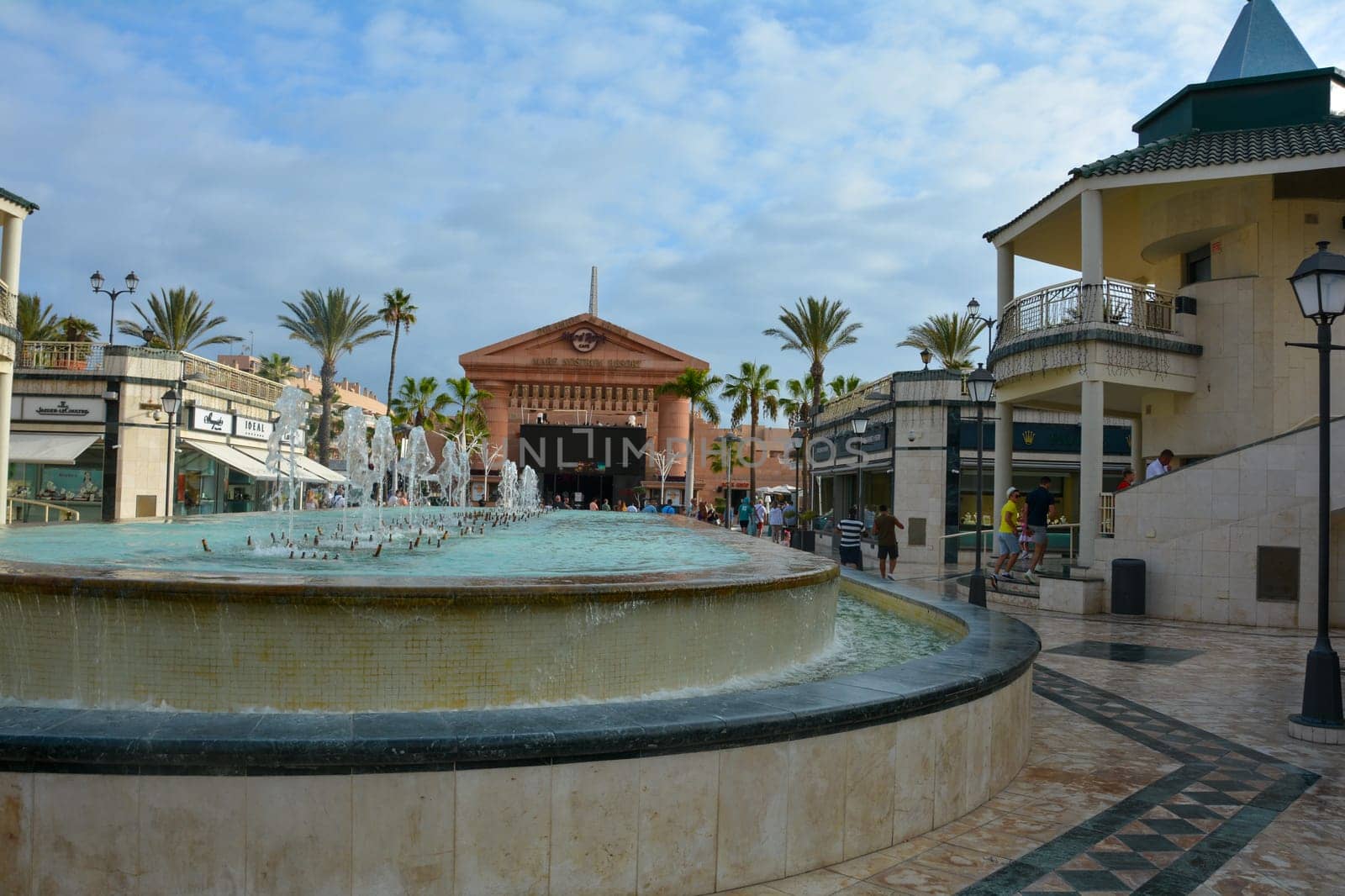 Centro Comercial Safari Shopping Mall, Playa de la Americas, Tenerife, Spain August 12, 2022 - Water fountain overlooking the Hard Rock Cafe with blue sky