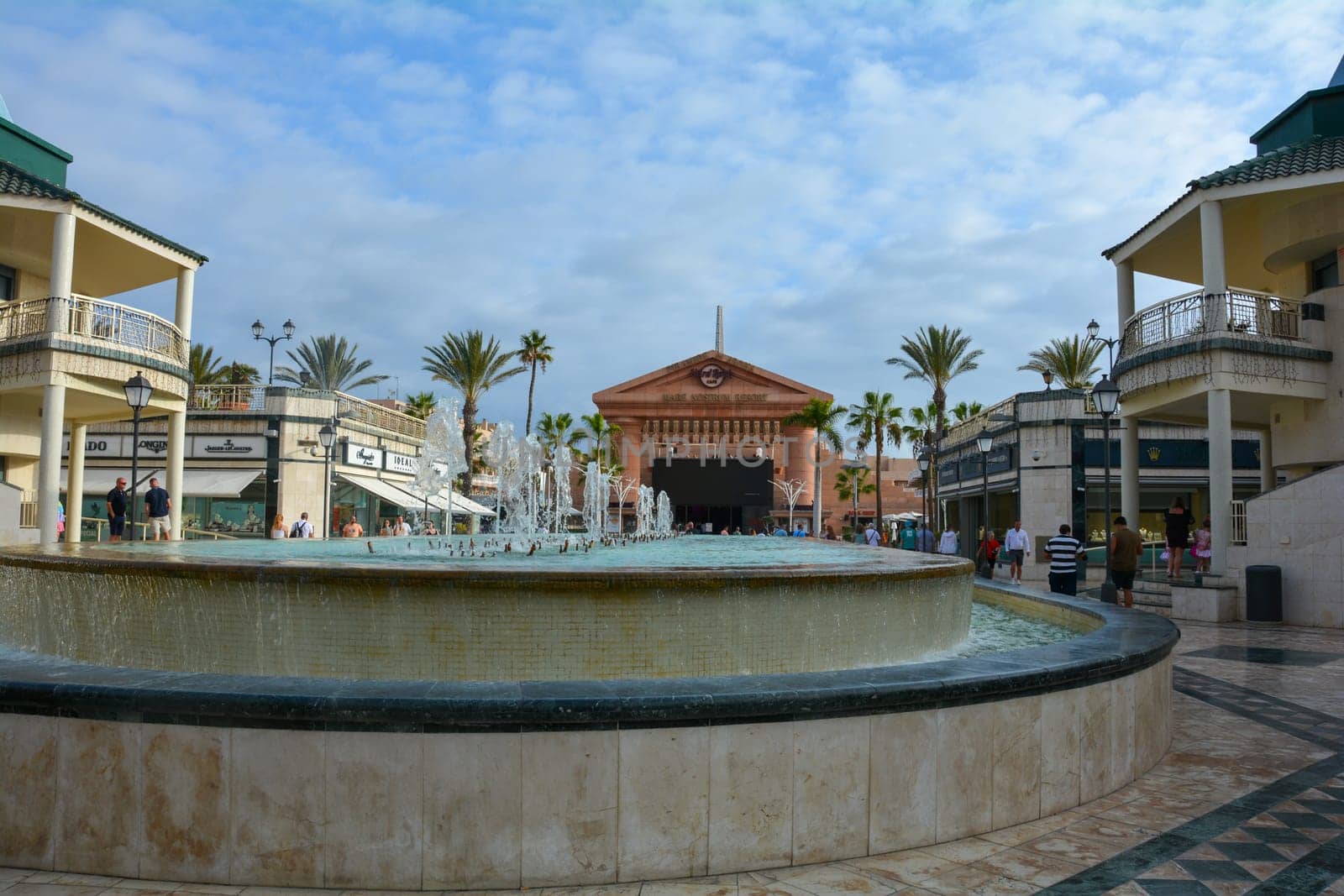 Centro Comercial Safari Shopping Mall, Playa de la Americas, Tenerife, Spain August 12, 2022 - Water fountain overlooking the Hard Rock Cafe with blue sky