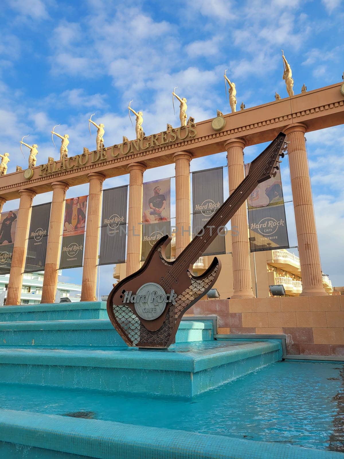Hard Rock Cafe, Playa de la Americas, Tenerife, Spain August 12, 2022 - Building exterior with guitar , fountain and some archers and blue sky