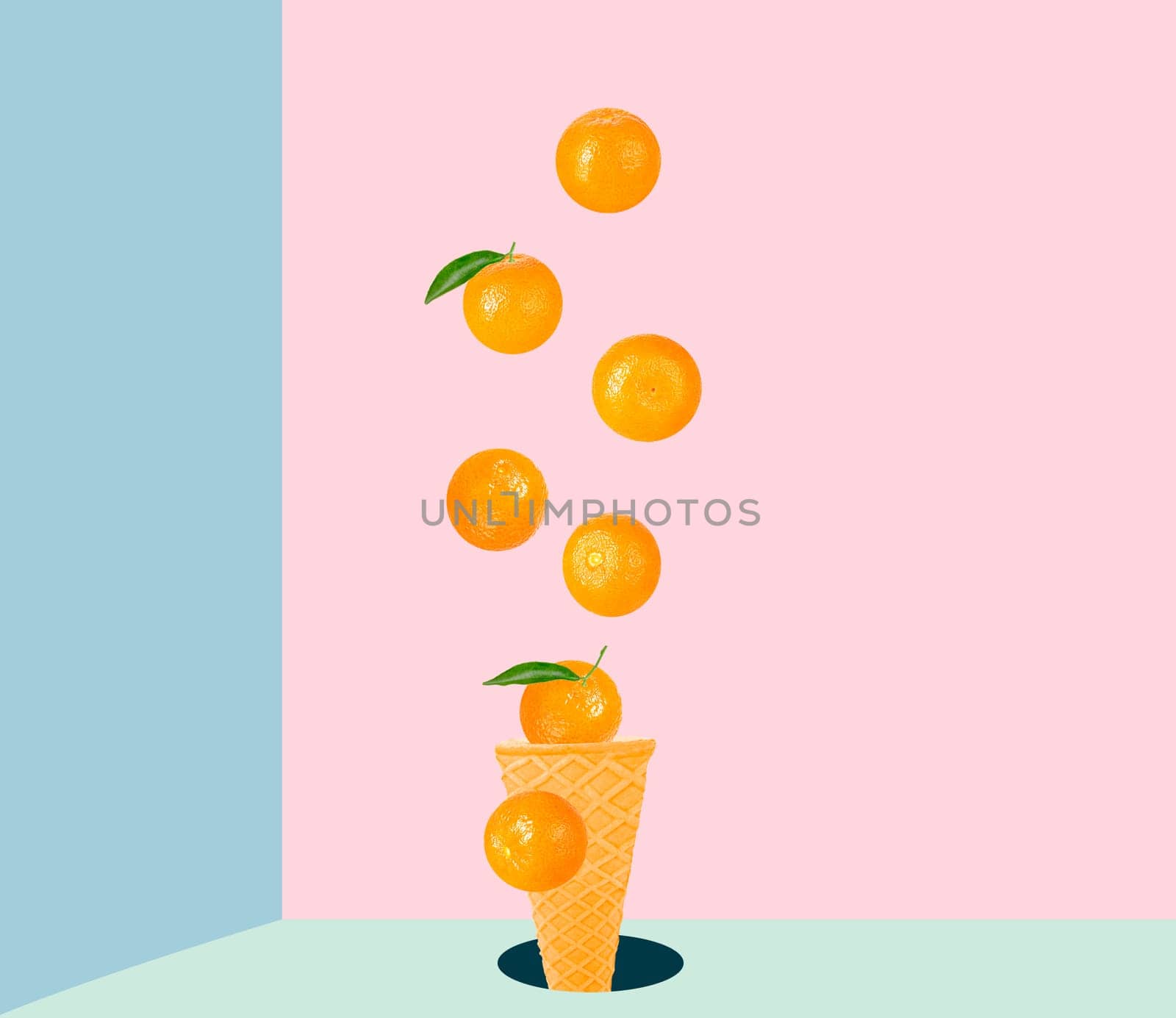 Isolated ice cream cone with fruits in the air. Seven falling whole tangerines on colored table with clipping path as package design element and advertising. Full depth of field.