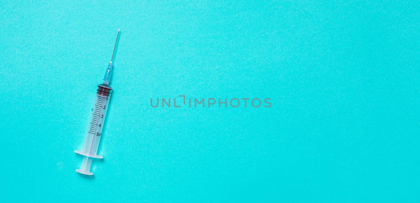 Vaccination debate concept. Biotechnology banner with medical syringe. Copyspace for text. flatlay.