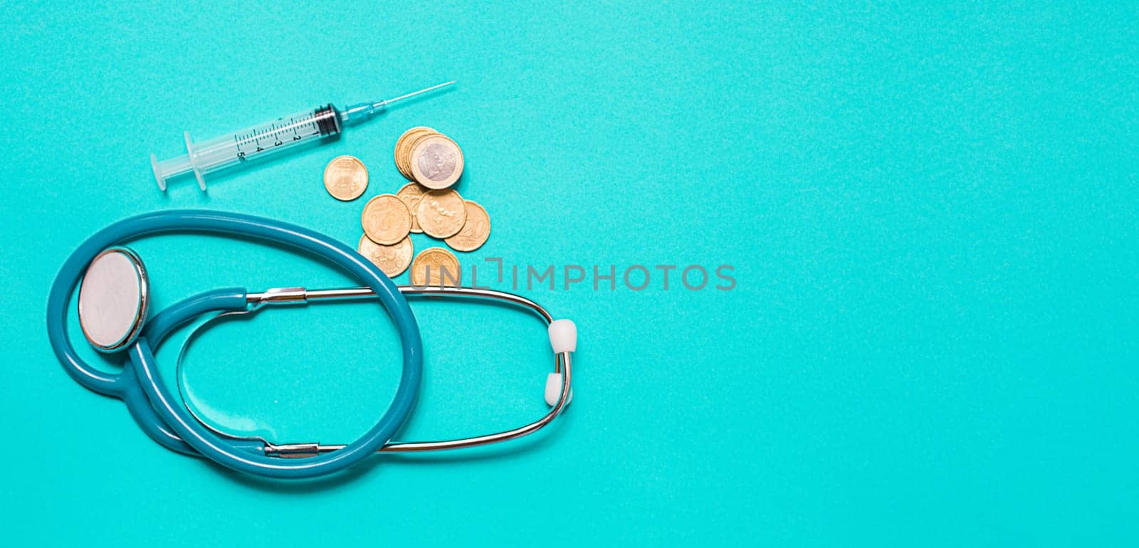 Concept of scientific research in medicine. Biotechnology banner with medical syringe stethoscope and money. Copyspace for text. flatlay.