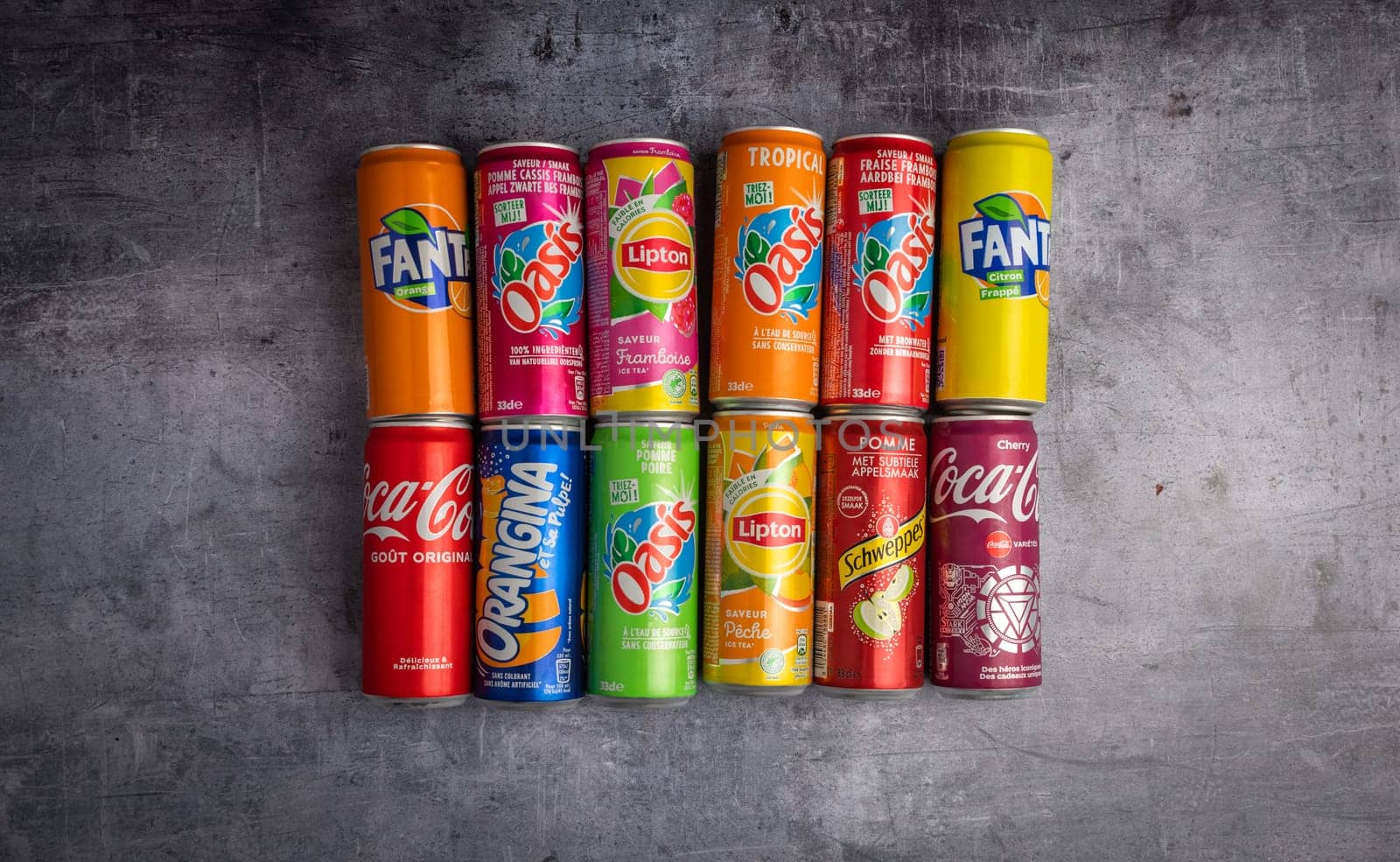 december 21 2022 : Lyon, Rhone Alpes Auvergne, France : groups of cans of sweetened sodas. Famous brands on a background of material