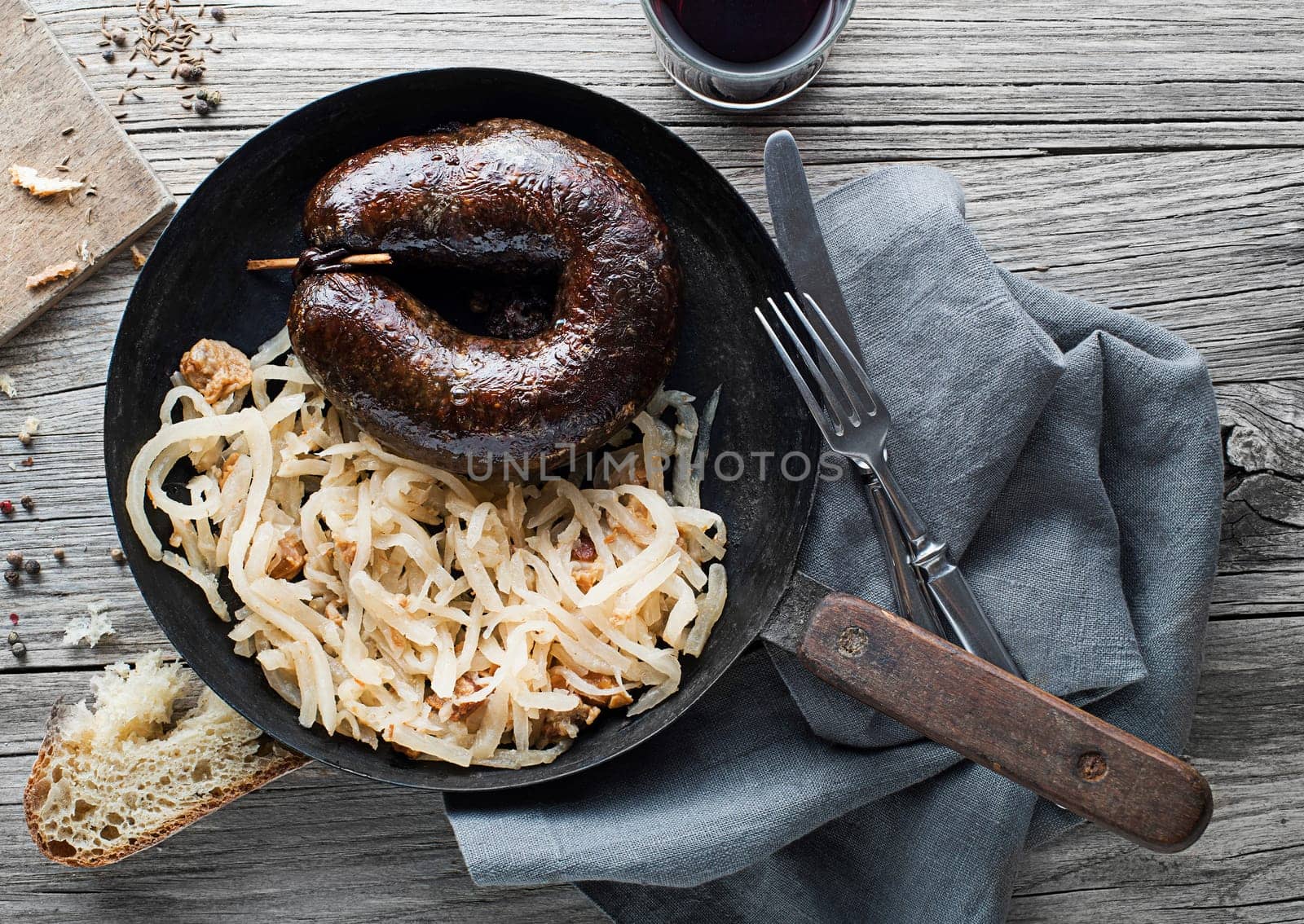 Bloody sausage morcilla and stewed sour turnip close up. Traditional Slovenian dish with roasted bloody sausage