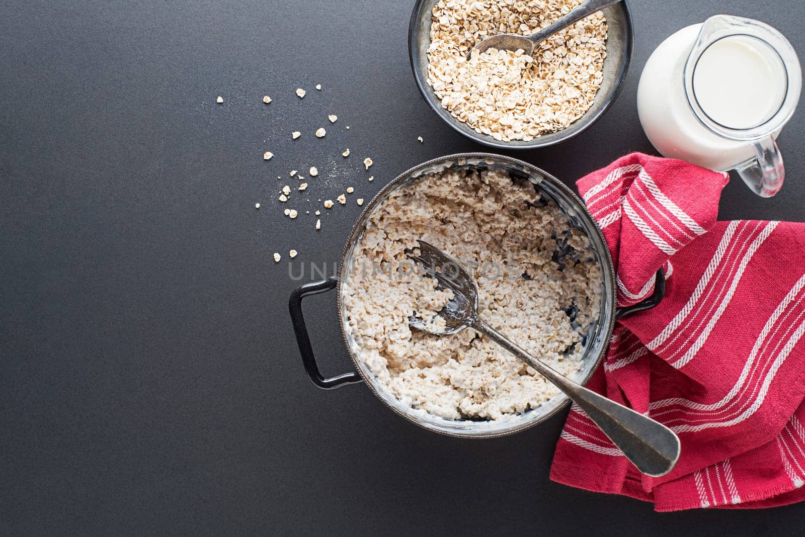Oatmeal bowl. Cooked oatmeal served with fresh milk. Healthy food, diet. Top view.